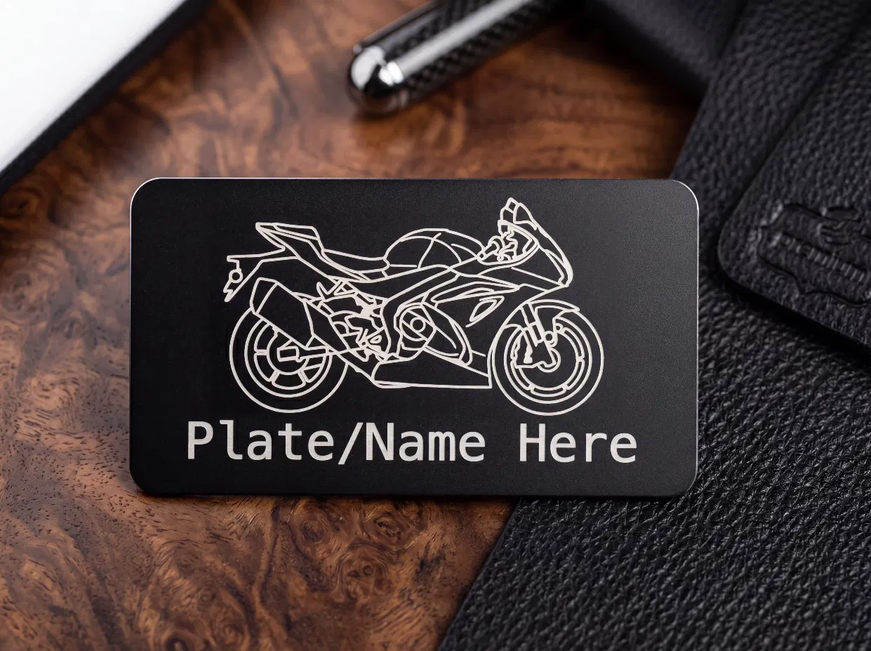 Matte black metal tag laser engraved with a sportbike silhouette and custom name