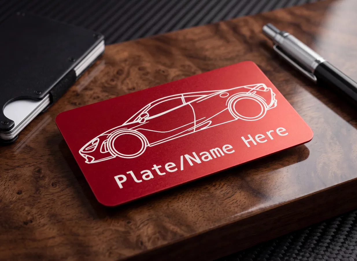 Scarlet anodized metal tag laser engraved with a supercar profile and custom name